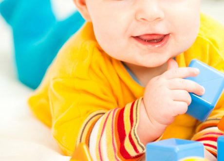 bigstockphoto_Happy_Baby_Girl_Playing_With_M_7239659